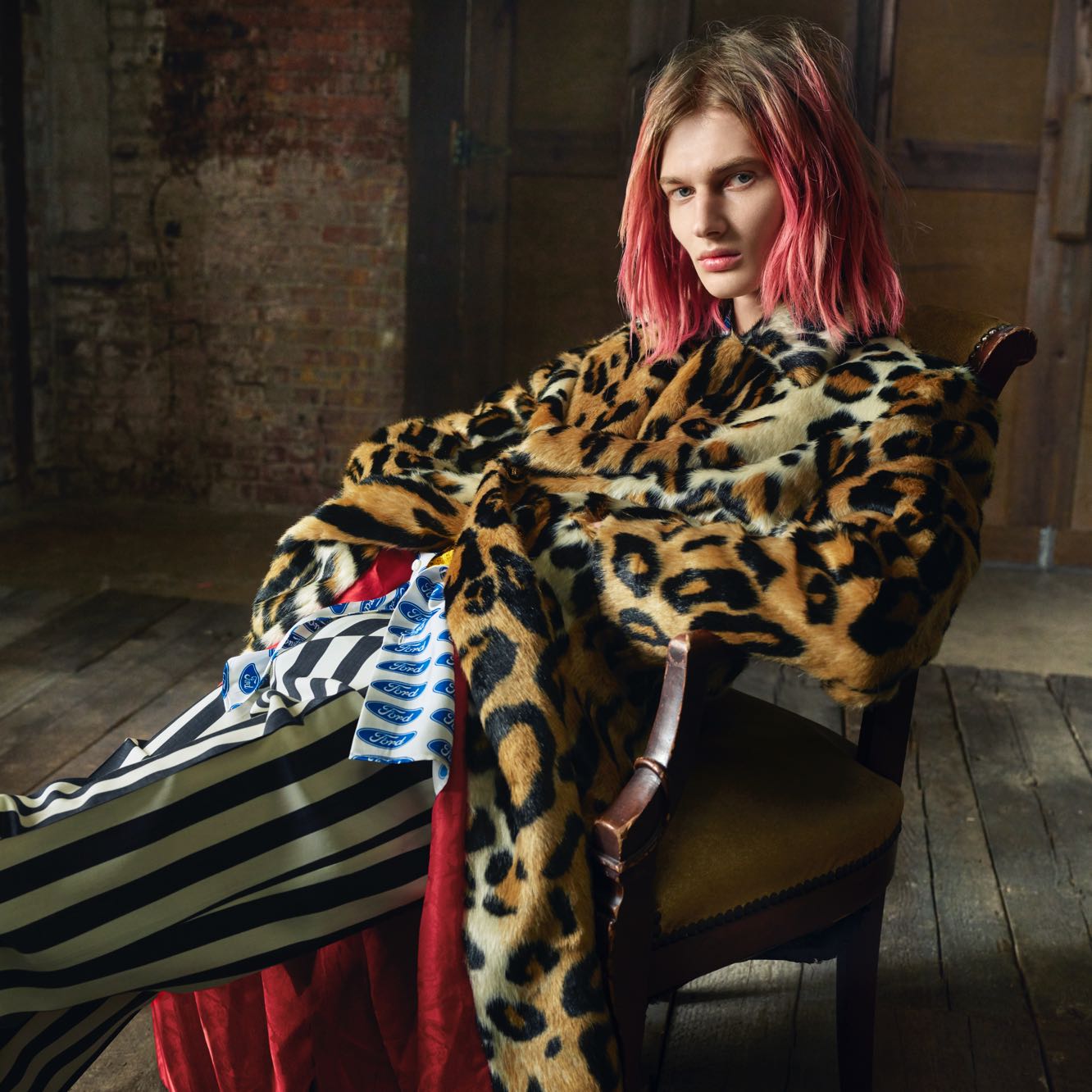 Pink haired model wears Versace x Ford Logo Print Shirt under leopard print coat