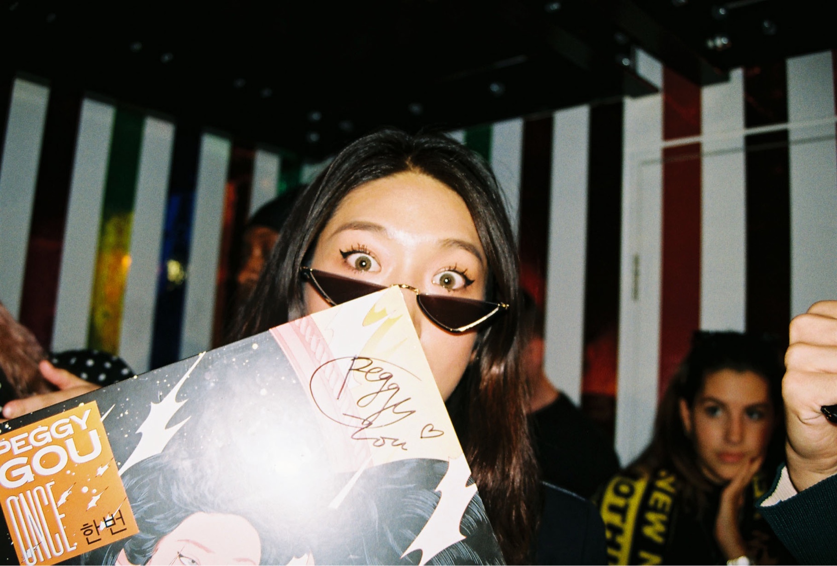 Close-up of Peggy Gou holding one of her signed vinyls