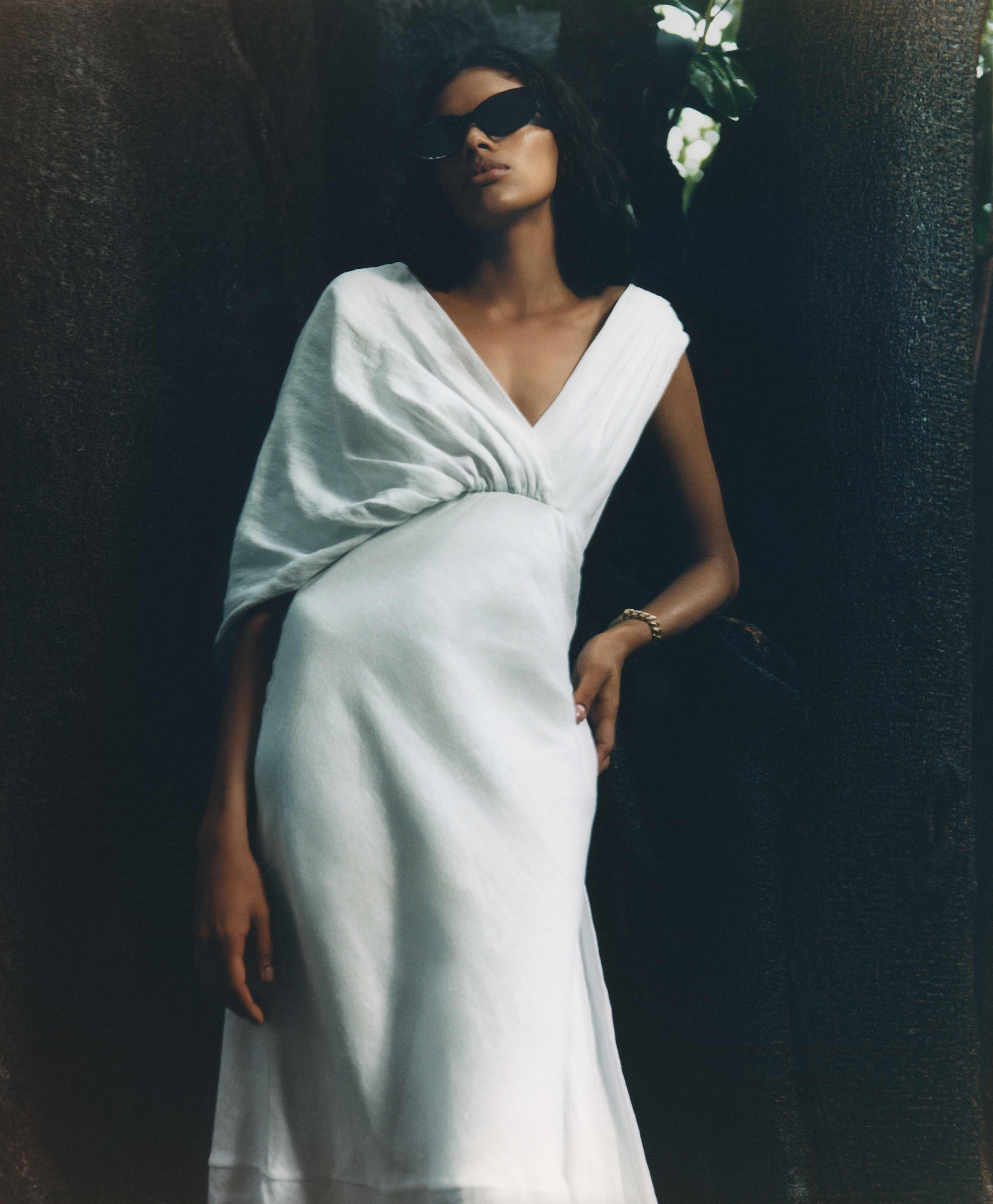 Model wears white dress by Miu Miu